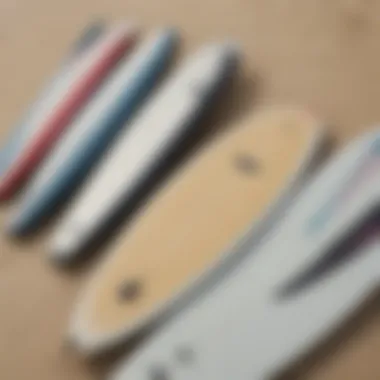 Close-up of surfboards lined up on a sandy beach