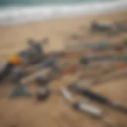 A selection of surf fishing rods and reels displayed on a sandy beach