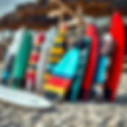 A selection of body surfing boards displayed on a sandy beach.