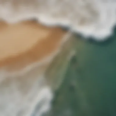 An aerial view of a scenic beach with skimboarders catching waves, illustrating the thrill of the sport.