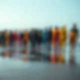 Vibrant wetsuits lined up on the beach