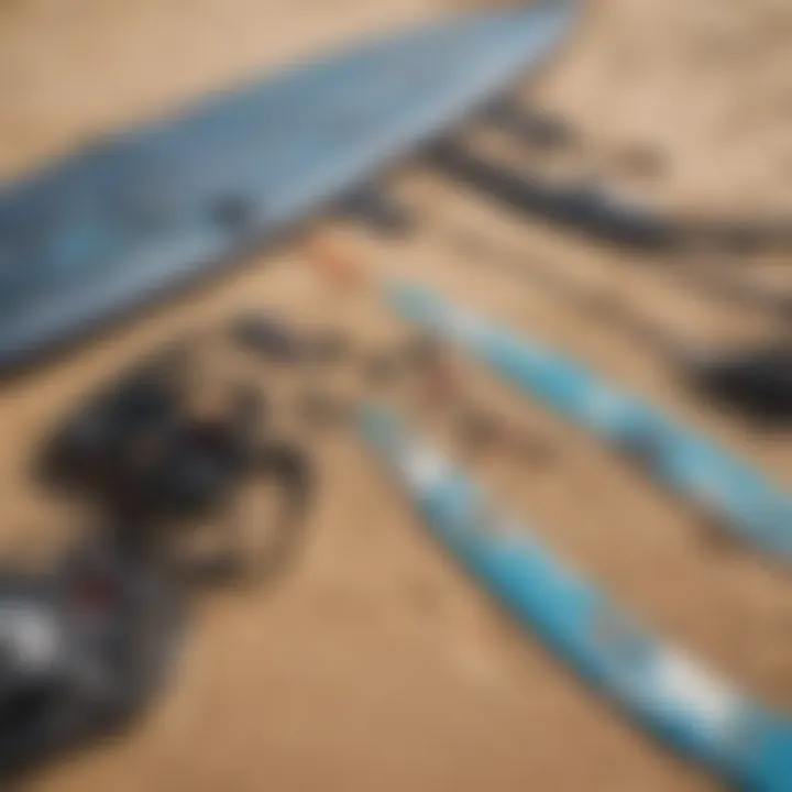 A close-up of essential kitesurfing equipment laid out on the sand