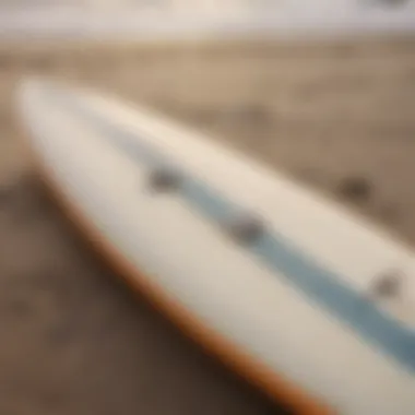 A close-up of a surfboard on the sandy shore, ready for the next adventure.