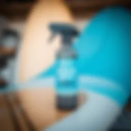 Close-up of Surf City Garage Black Edge Detailer bottle with surfboard in background