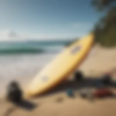 Surfboard and gear laid out on the sand