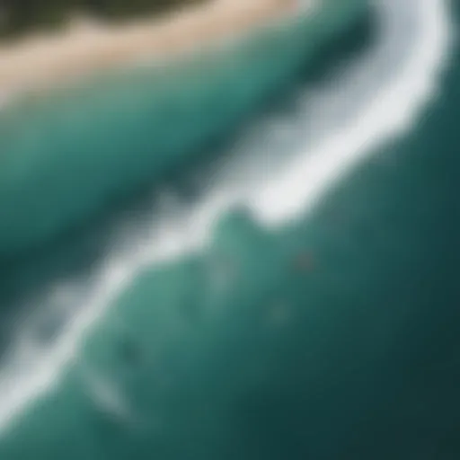 Aerial view of pristine beach with surfers riding waves