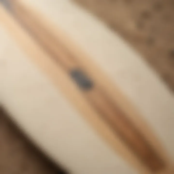 A close-up of a used almond surfboard highlighting its craftsmanship and detail