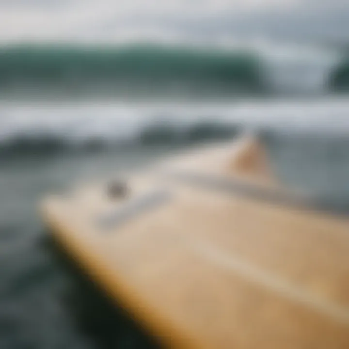 A close-up view of the FCS single fin setup on a surfboard.