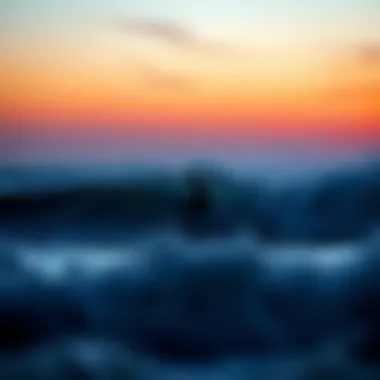 A surfer catching a wave at sunset
