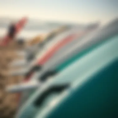 A close-up of surfboards lined up on the beach