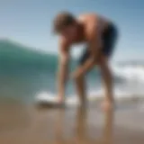 A surfer experiencing a calf cramp on the beach