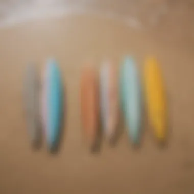 A variety of skim boards displayed on a sandy beach.