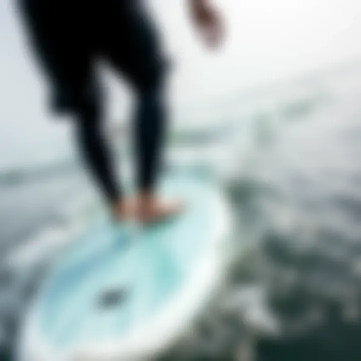 Skill Development on the Water A surfer practicing on a learner surfboard in gentle waves, emphasizing the importance of skill development.