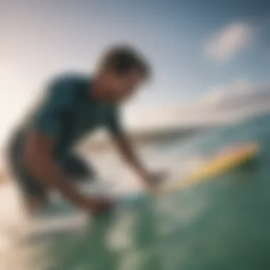 A surfer applying wax with a surf brush on a vibrant surfboard