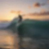 Surfer riding a wave at sunrise